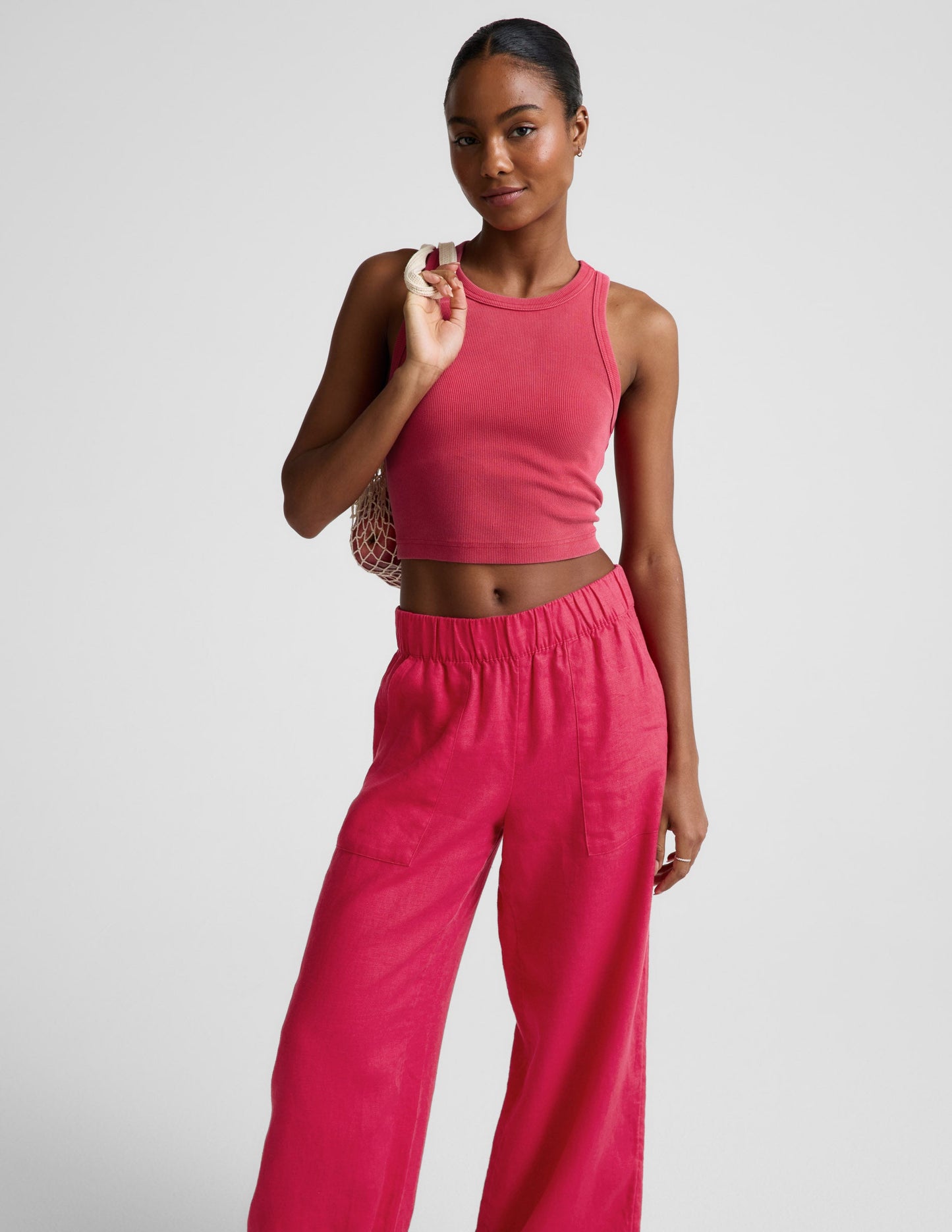 Woman wearing Pink SoftWash Linen Easy Wide Leg Pant 29"™ with slant pockets, paired with a matching tank top.