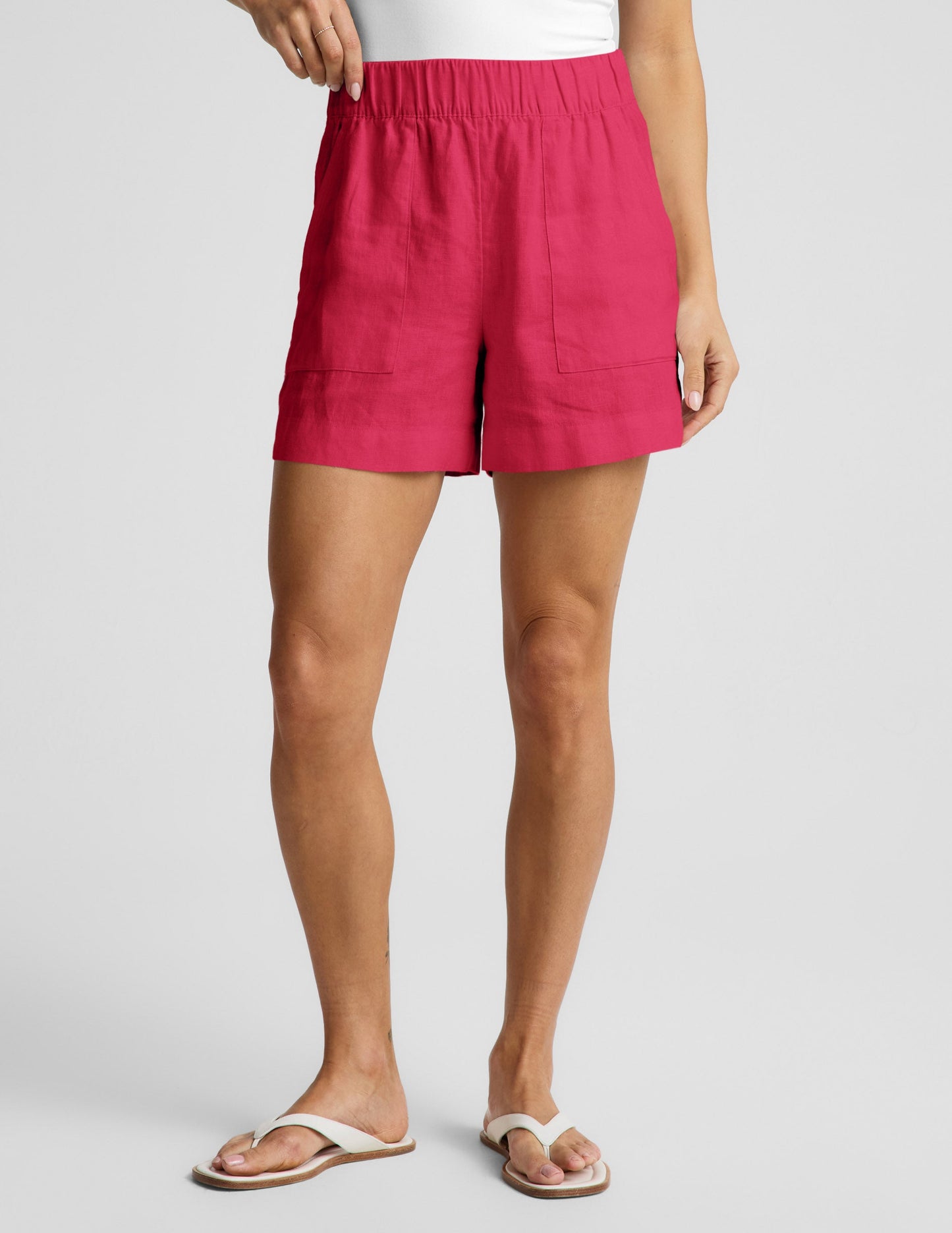 Woman wearing Fuchsia SoftWash™ Linen Easy Short with front patch pockets, paired with a white top and sandals.