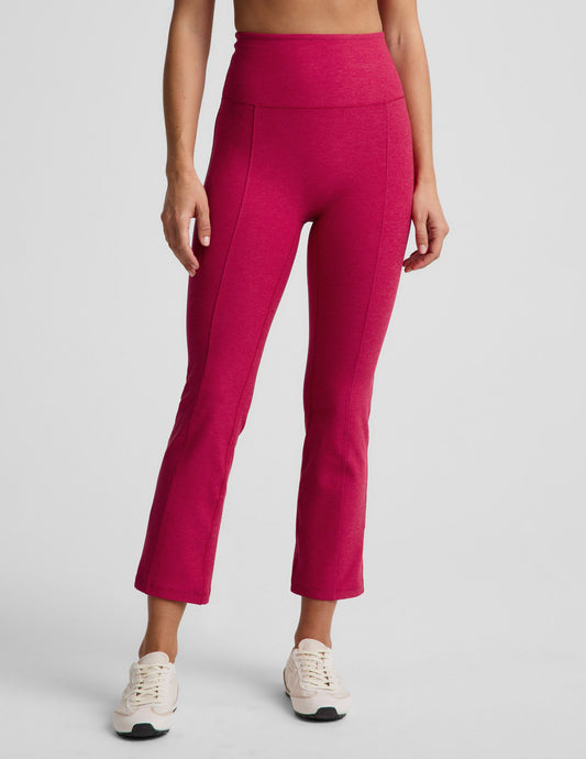 Woman wearing Fuchsia Spacedye™ Pintuck Kick Flare High Waisted Pant with cream sneakers, featuring front pintuck seams.