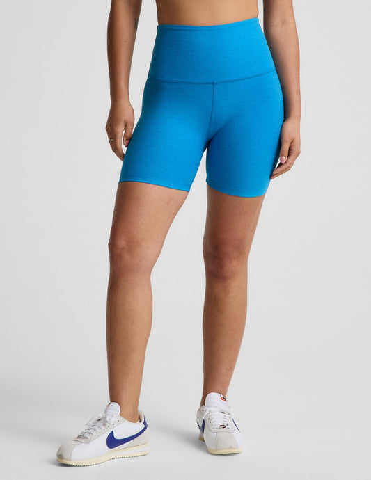 Woman wearing Blue Spacedye™ Keep Pace 5" Biker Short with high waistband and white sneakers. Front view.