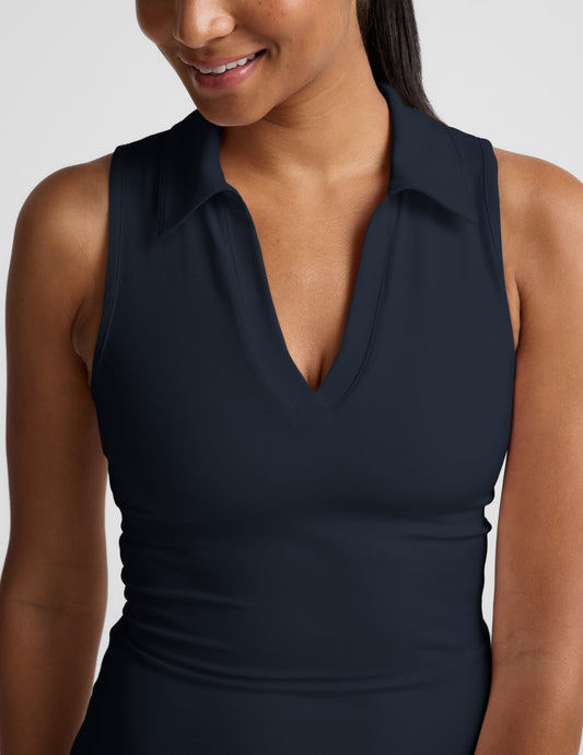 Woman wearing a sleeveless mini athletic dress against a plain background.