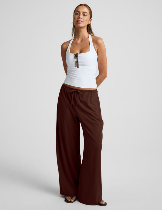 Woman wearing Brown Solstice™ Drawstring Wide Leg Pant 29" with a white halter top and black sandals.