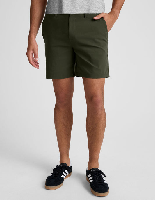 Olive Essential Men's Chino 7" Short with a 7-inch inseam, side pockets, and belt loops shown on a model.