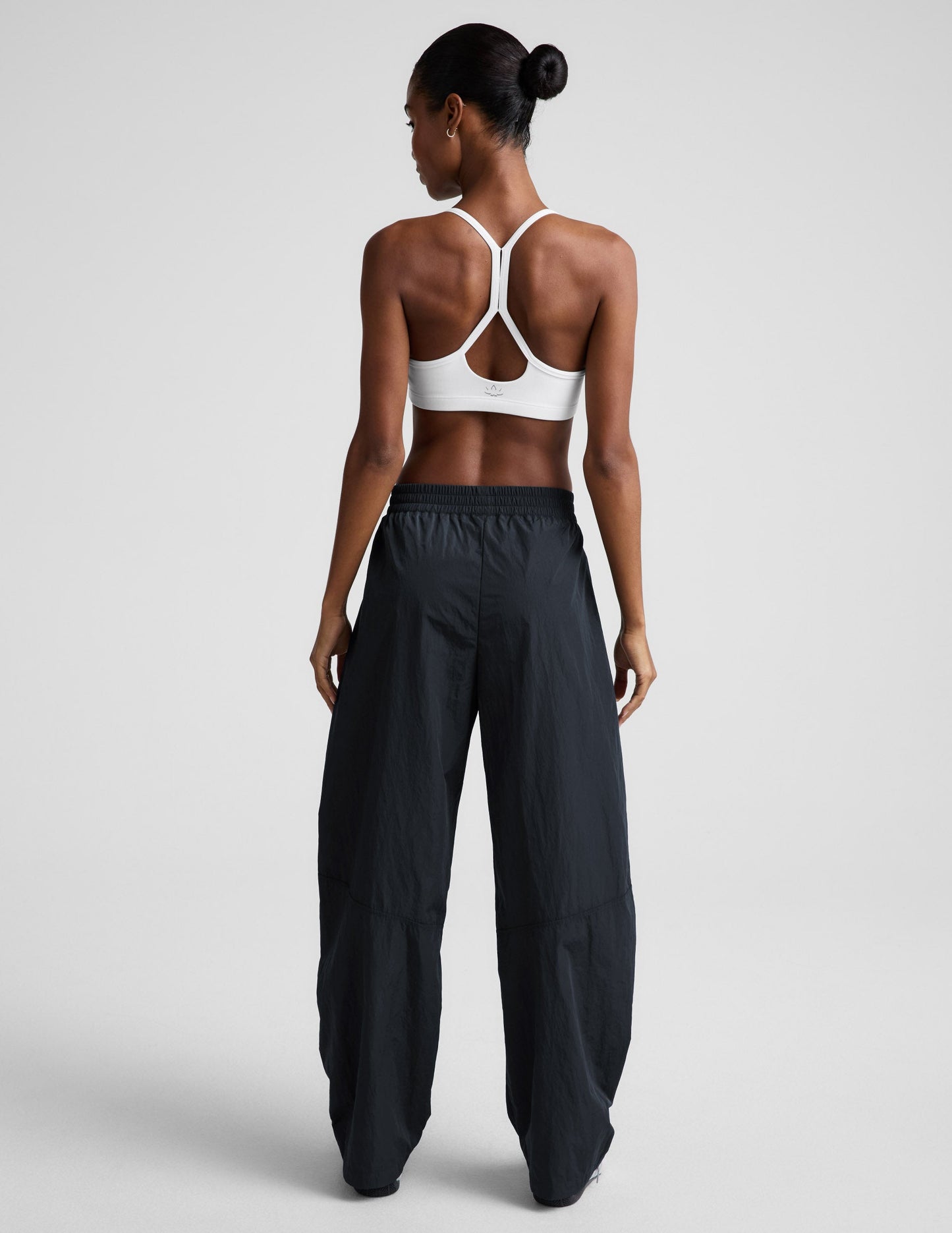 Back view of the Limitless Mid-Rise Barrel Leg Pant in dark gray, showing its gathered waist and wide barrel-leg fit.