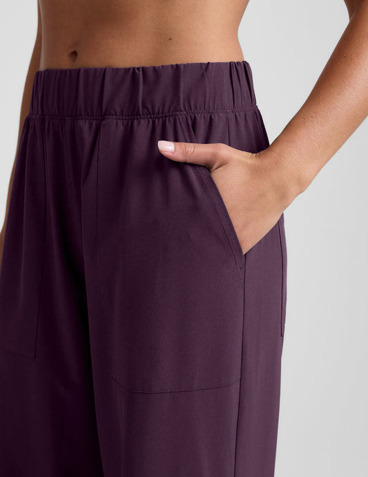 Woman wearing Dark Plum Easy Wide Leg Pant 29"™ with hand in side slant pocket and gathered elastic waistband.