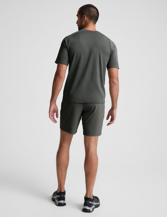 Man wearing Olive Pivotal 2.0™ Men's Short 7" paired with a matching t-shirt, rear view.
