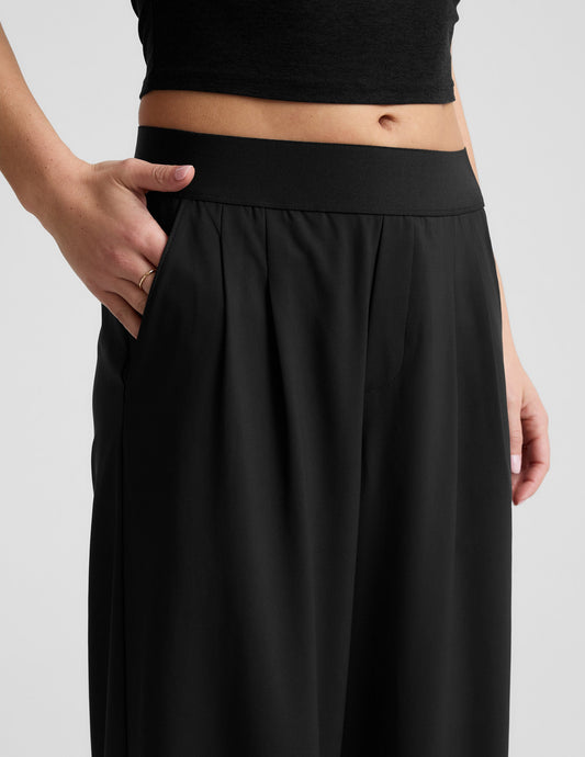 Black Elasticated Trouser Pant 29" with wide elastic waistband, pleats, and a hand in a side slant pocket.