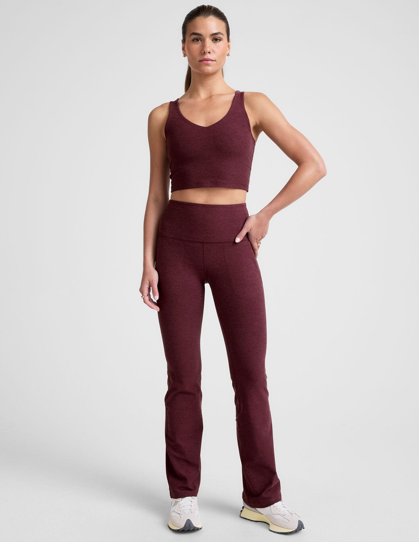 Woman wearing Maroon Spacedye High Waisted Practice Pocket Bootcut Pant with a matching tank and white sneakers.