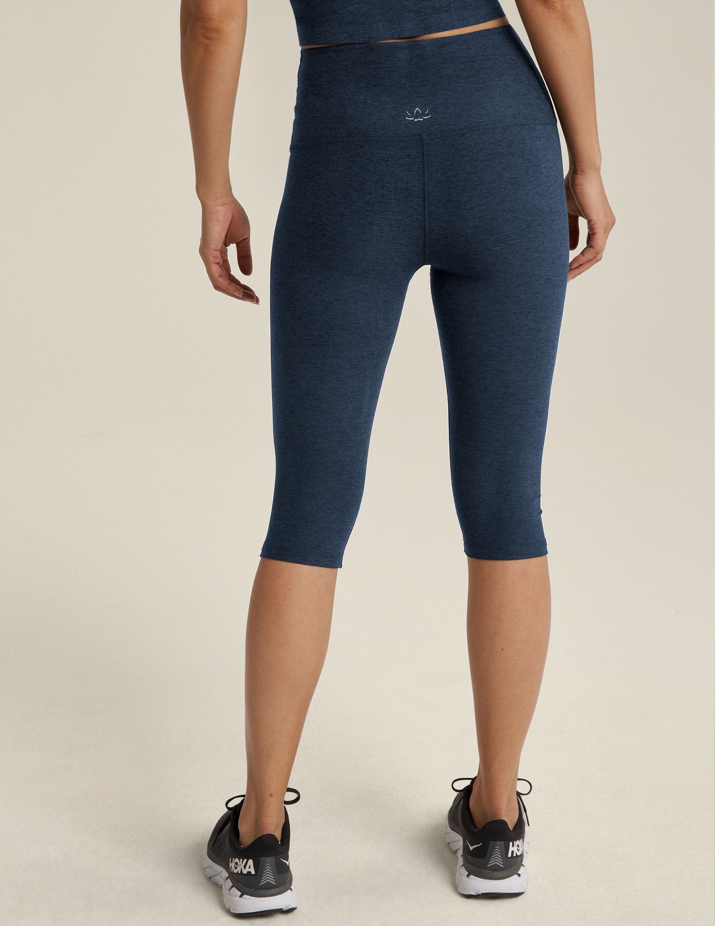 Rear view of the Spacedye Pedal Pusher High Waisted Legging in navy marled fabric, hitting just below the knee.