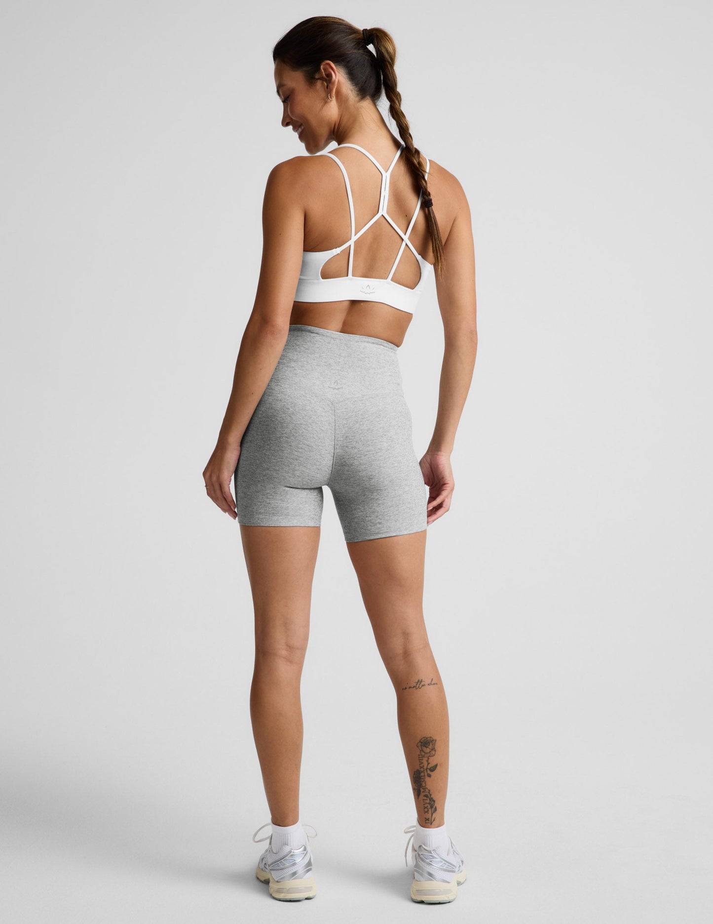 Woman wearing Gray Spacedye™ Streamline 5" Short, rear view, showing V-detail back waistband and white sports bra.