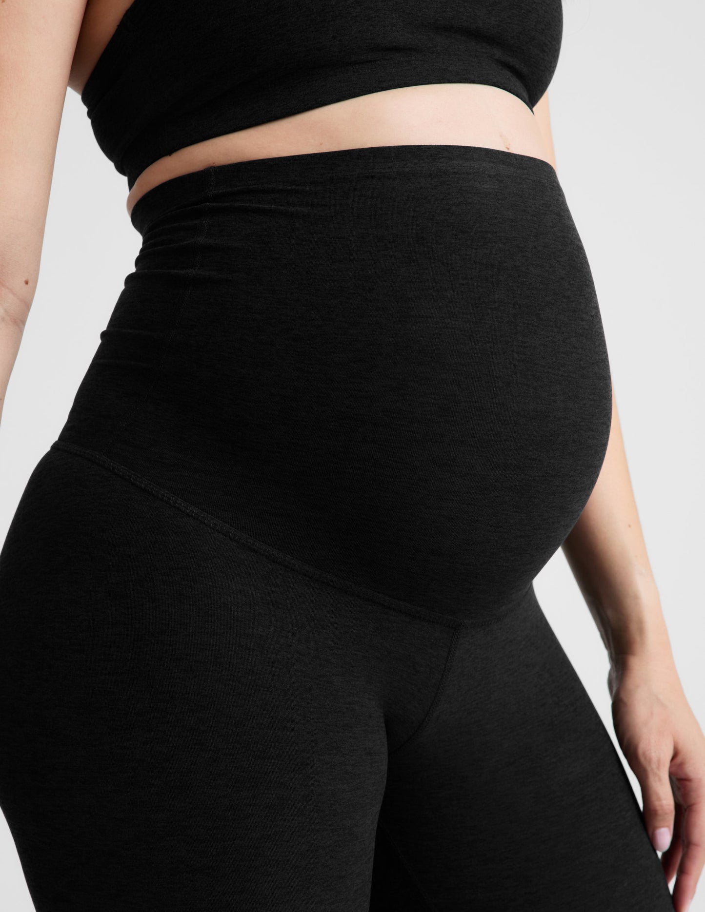Woman wearing Black Spacedye™ Love The Bump Maternity 20.5" Capri Legging with a matching black crop top.