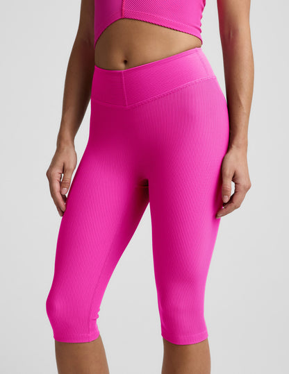 Woman wearing Pink Impulse Ribbed V-Waist Pedal Pusher Legging paired with a matching pink top.