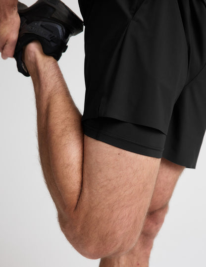 Close-up of man wearing Black WarpLite Range Lined Short™ paired with black sneakers, showing the inner liner detail.