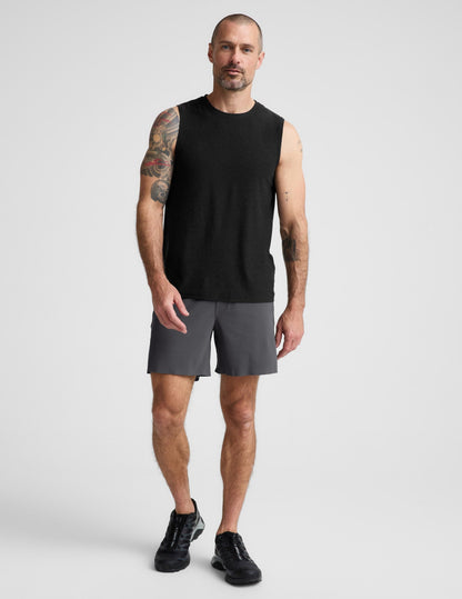 Man wearing Gray WarpLite™ Range Lined Short with a 6-inch inseam, paired with a black tank top and black sneakers.
