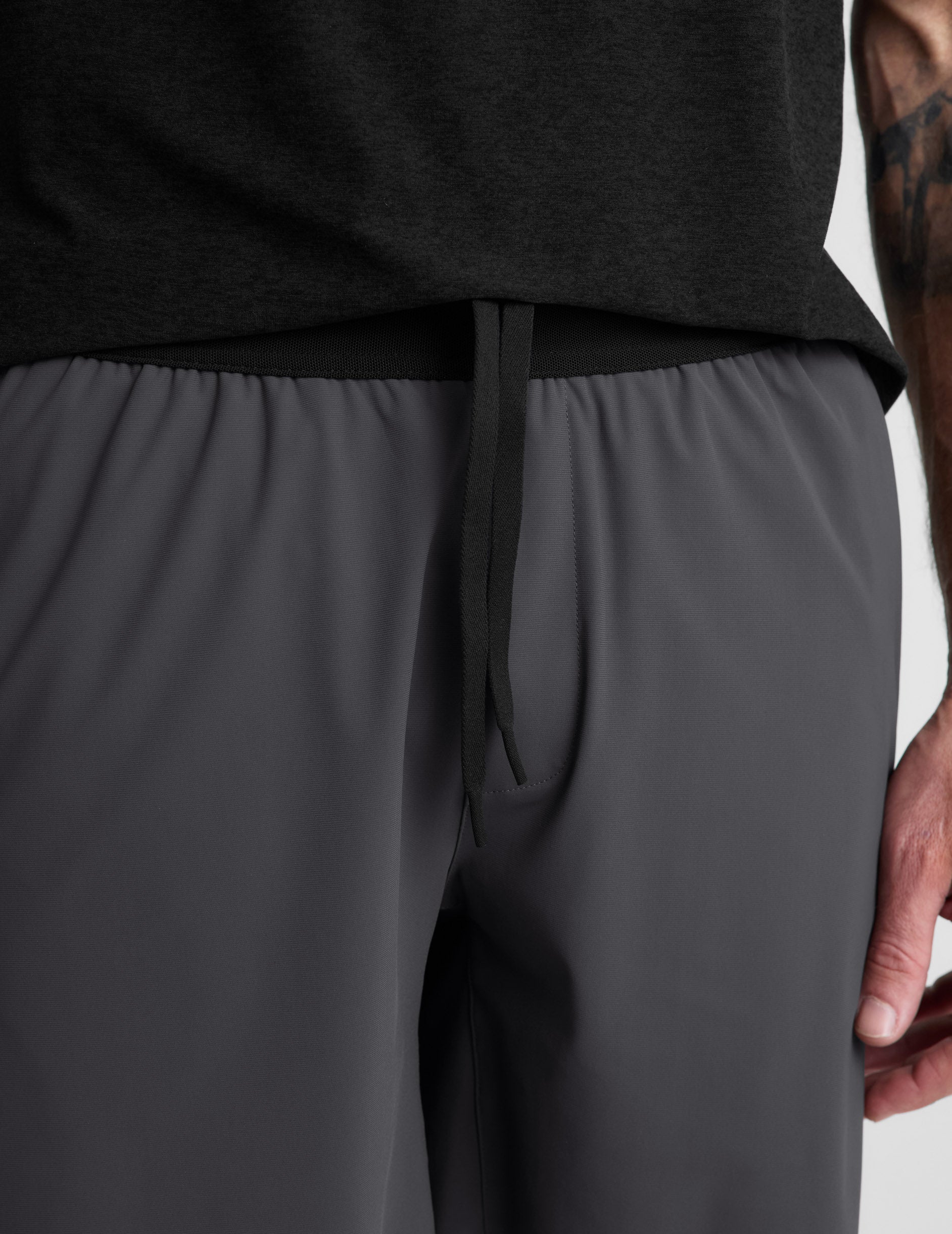 Man wearing Gray WarpLite Range Lined Short™ with a black t-shirt, detailing the elastic waistband and drawcord.