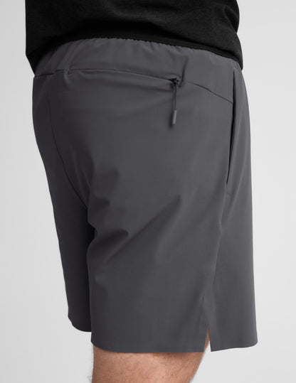 Man wearing Gray WarpLite™ Range Lined Short with a rear zipper pocket, paired with a black shirt.