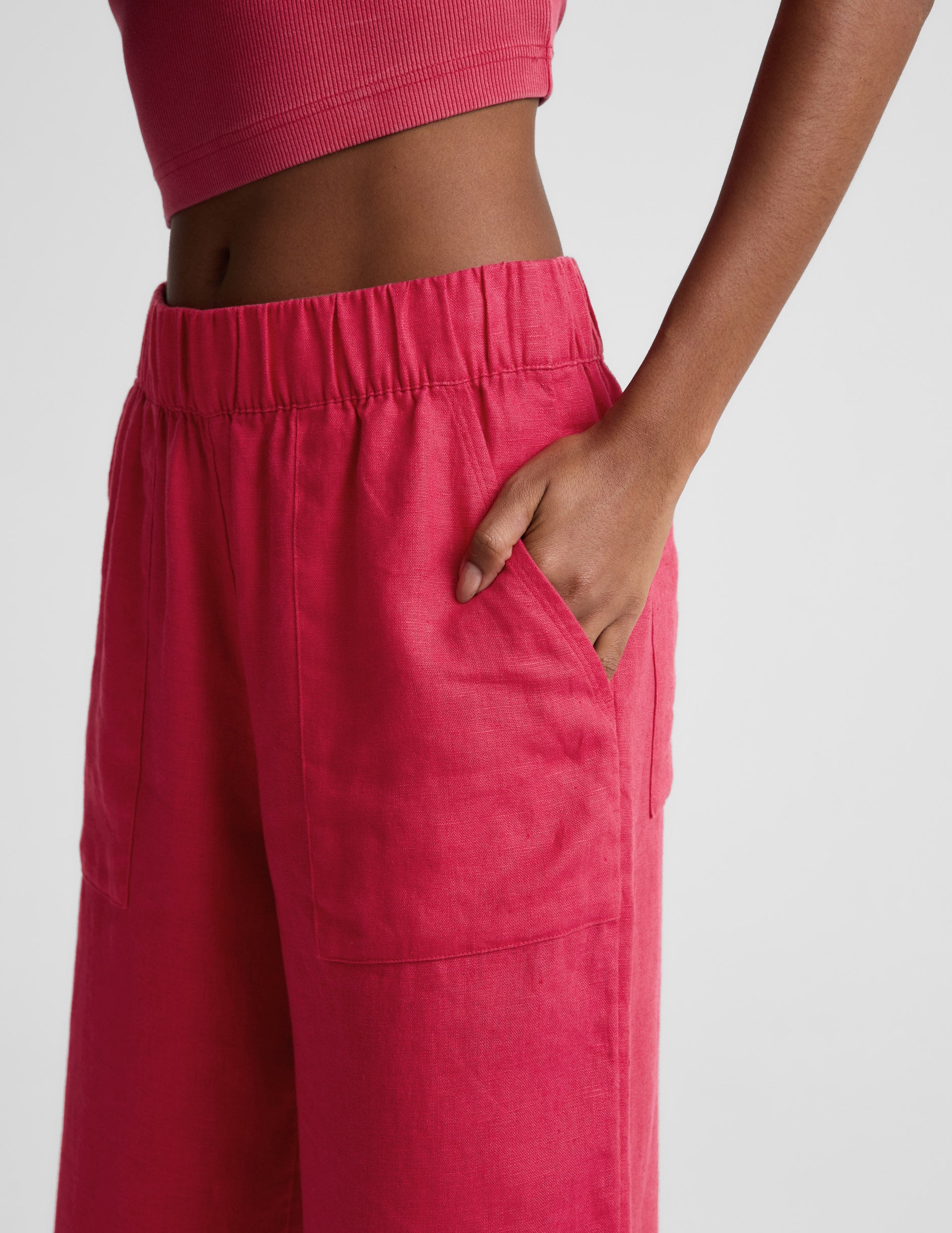 Side profile of woman wearing Pink SoftWash™ Linen Easy Wide Leg Pant 29" with hand in pocket and a pink crop top.