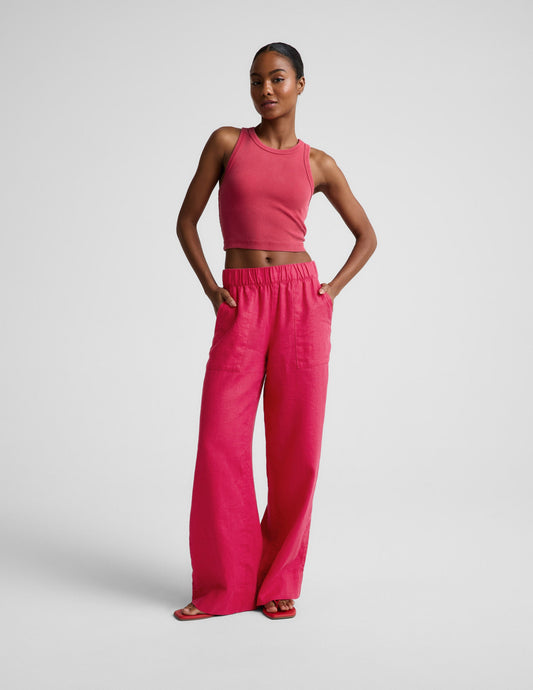 Woman wearing Pink SoftWash Linen Easy Wide Leg Pant 29" paired with a matching pink tank top, hands in slant pockets.