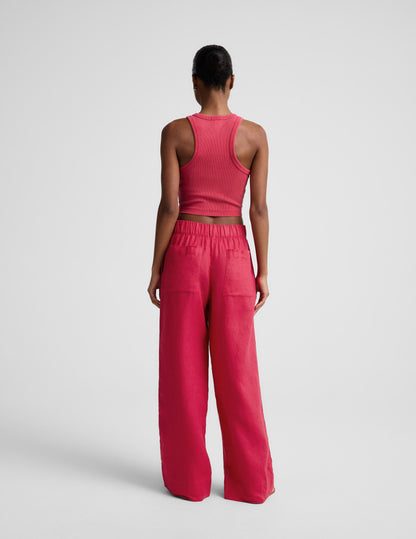 Woman wearing Pink SoftWash Linen Easy Wide Leg Pant 29"™ from a rear view, paired with a matching pink tank top.