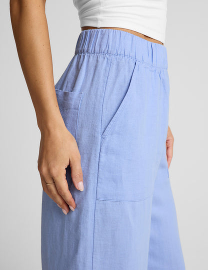 Woman wearing Blue SoftWash Linen Easy Wide Leg Pant 31" with a white top, showing the side pocket and elastic waistband.