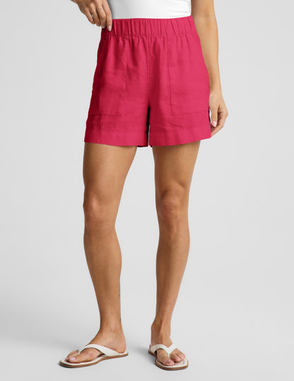 Woman wearing Fuchsia SoftWash™ Linen Easy Short with front patch pockets, paired with a white top and sandals.