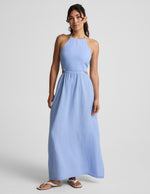 Woman wearing a light blue dress on a gray background.