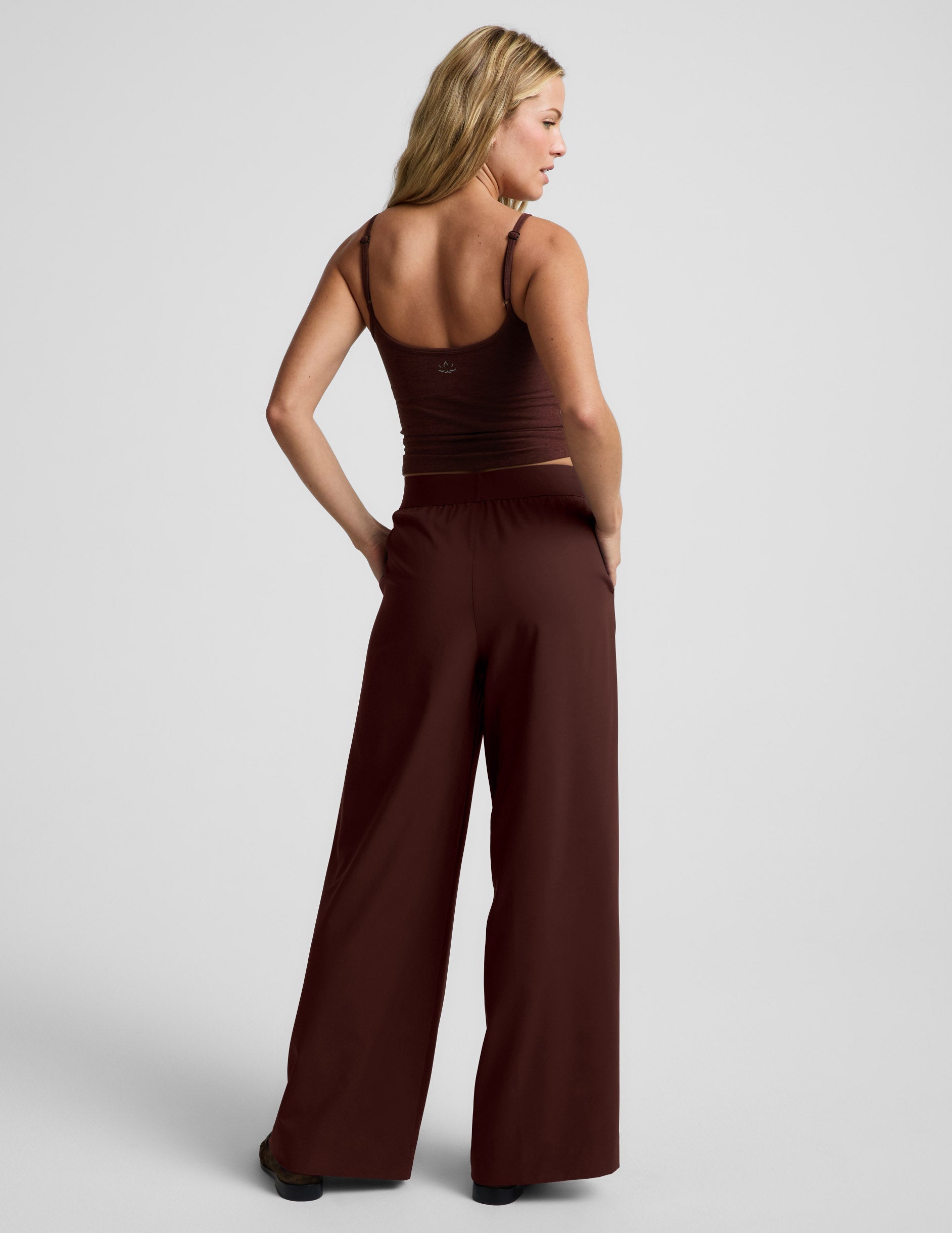 Woman wearing Brown Elasticated Wide Leg Pant 29"™ with a matching brown tank top, rear view with hands in pockets.