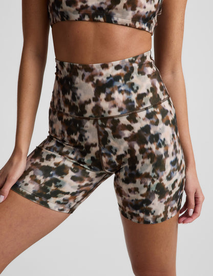 Woman wearing multi-color Dappled Roan SoftMark Keep Pace Biker Short™ with a high waistband and matching sports bra.