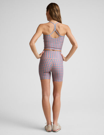 Woman wearing Sunwashed Gingham SoftMark Keep Pace Biker Short™ in rear view, paired with a matching gingham crop top.