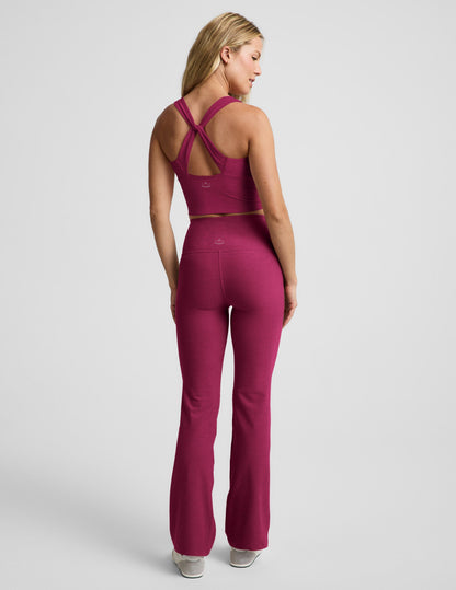 Woman wearing Fuchsia Spacedye™ High Waisted Practice Pocket Bootcut Pant 31" with a matching racerback tank. Rear view.