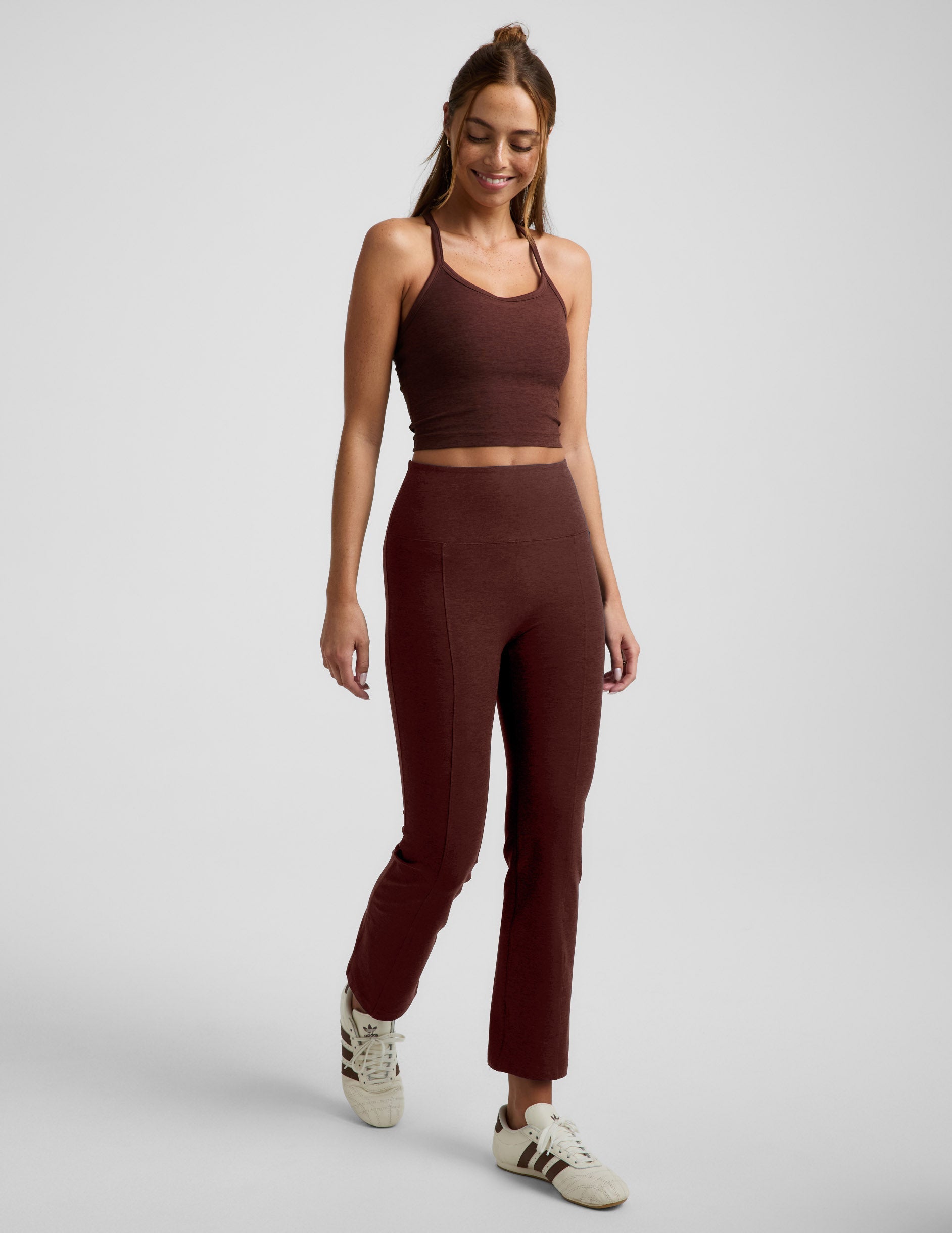 Woman wearing Maroon Spacedye™ Pintuck Kick Flare High Waisted Pant with a matching crop tank and cream sneakers.