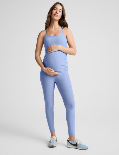 Woman wearing a light blue athletic outfit on a gray background