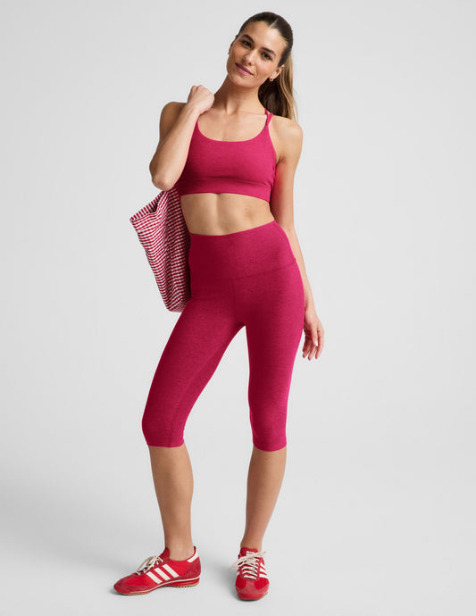 Woman wearing Fuchsia Spacedye™ Pedal Pusher High Waisted Legging with a matching sports bra and red sneakers.
