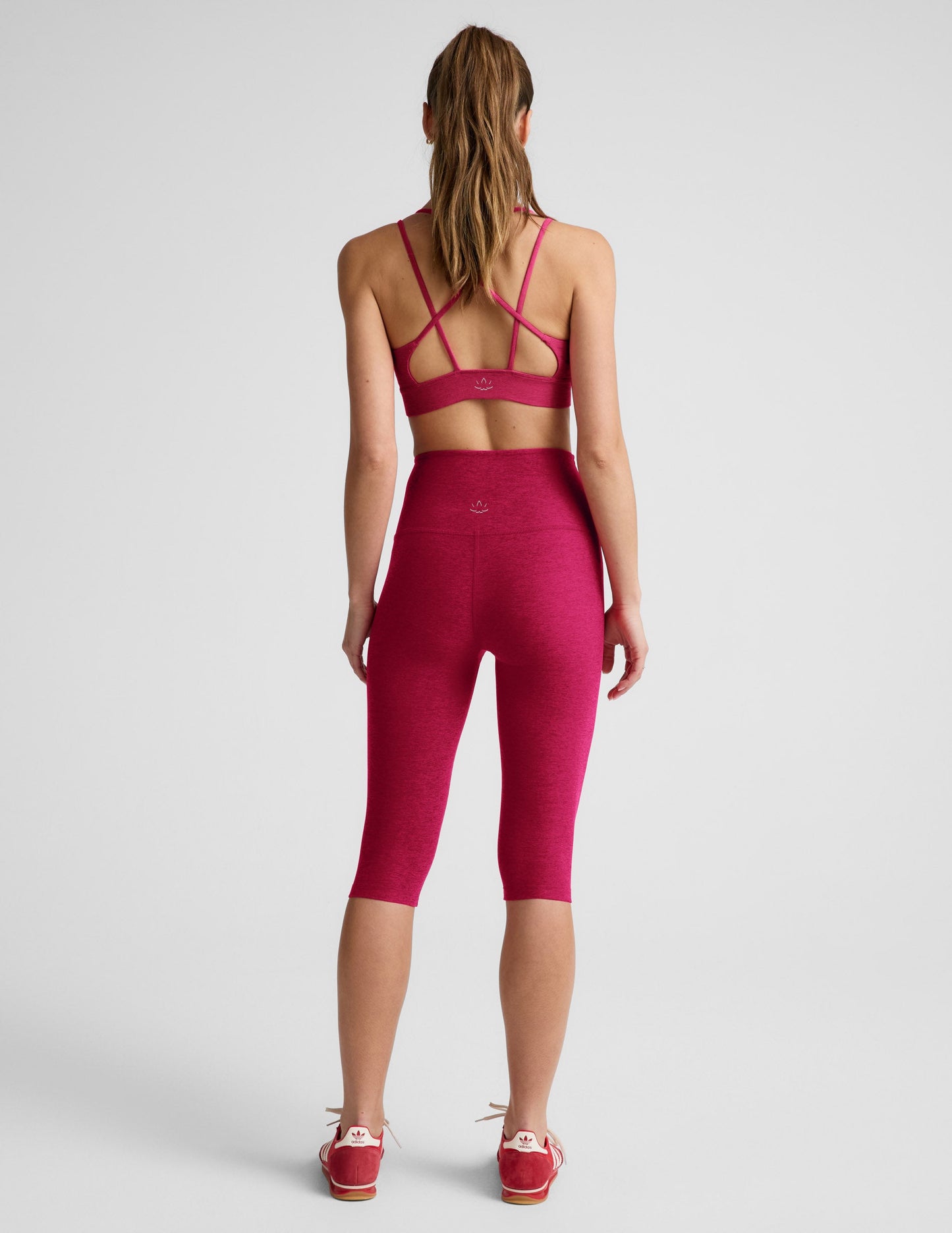 Woman wearing Fuchsia Spacedye™ Pedal Pusher High Waisted Legging paired with a matching sports bra, Rear view.
