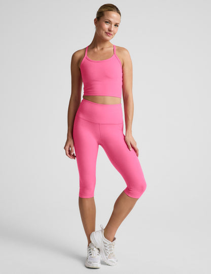 Woman wearing Pink Spacedye Pedal Pusher High Waisted Legging™ with a matching tank top and white sneakers.