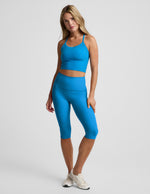 Woman wearing Blue Spacedye™ Pedal Pusher High Waisted Legging paired with a matching crop top and white sneakers.