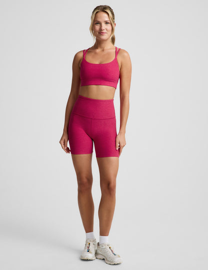 Woman wearing Fuchsia Spacedye™ Keep Pace 5" Biker Short paired with a matching sports bra and sneakers.