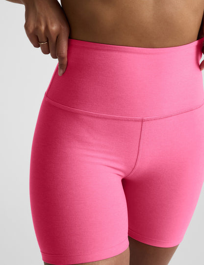 Woman wearing Pink Spacedye™ Keep Pace 5" Biker Short with a high waistband, paired with a bare midriff.