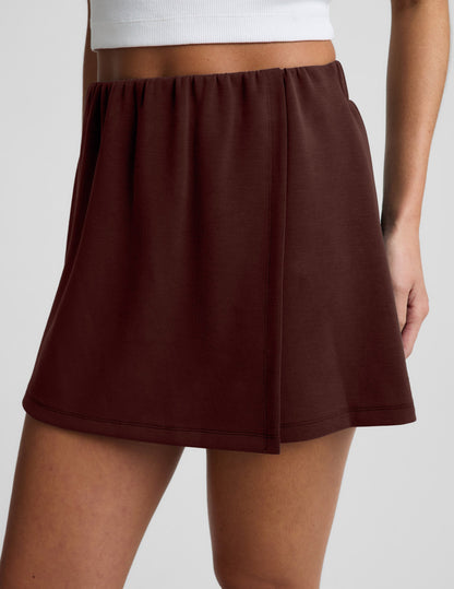 Woman wearing Brown Luxe Sandwash™ Skort paired with a white cropped tank top.
