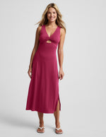 Woman wearing a red midi tank dress with a front center cutover against a light gray background.