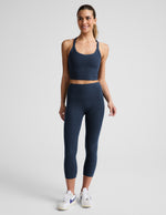 Woman wearing navy Spacedye™ Walk And Talk High Waisted Capri Legging with a matching tank top and white sneakers.