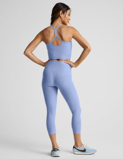 Woman wearing Blue Spacedye Walk And Talk High Waisted Capri Legging, rear view, paired with matching top and sneakers.