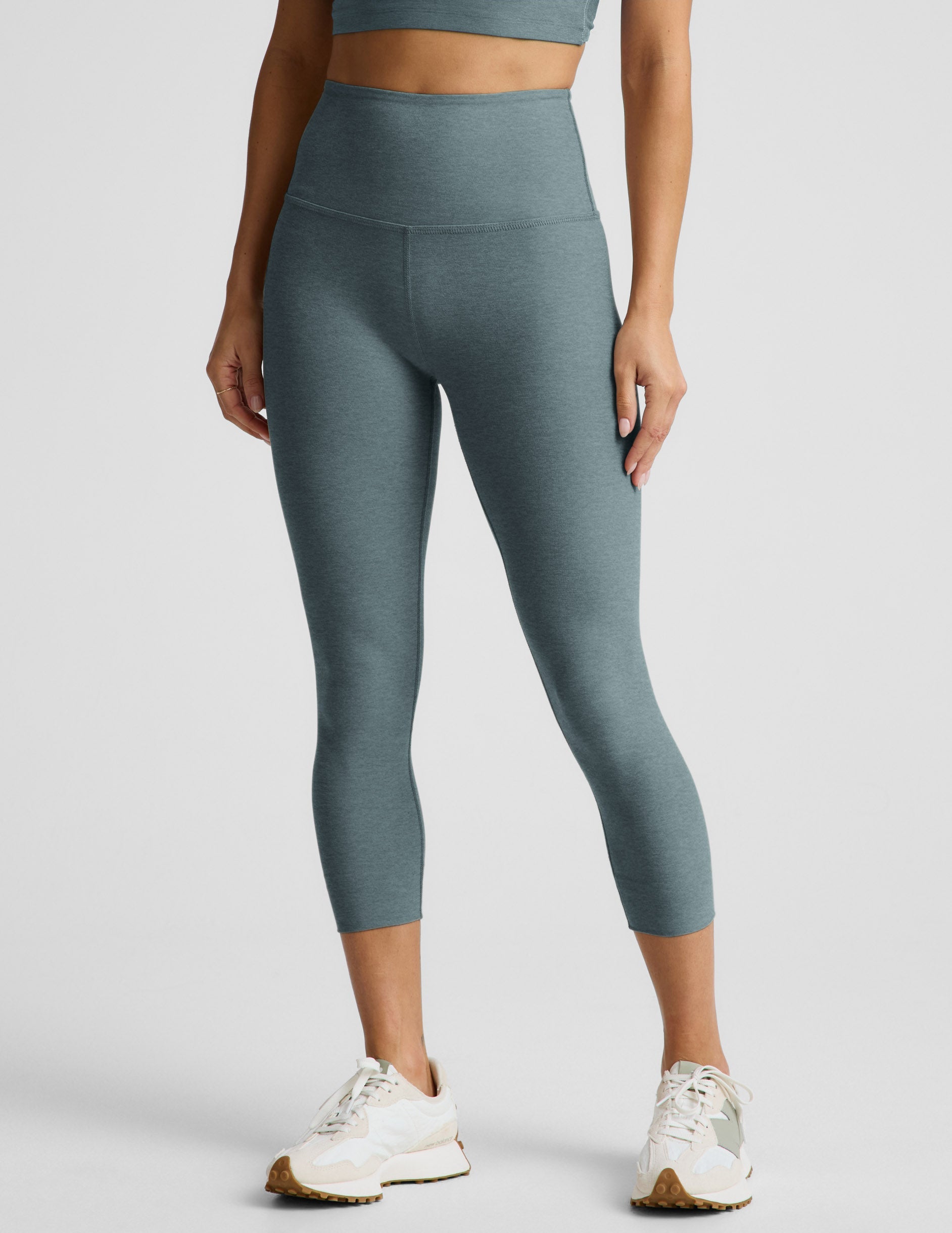 Woman wearing Green Spacedye™ Walk And Talk High Waisted Capri Legging paired with white sneakers and a matching top.