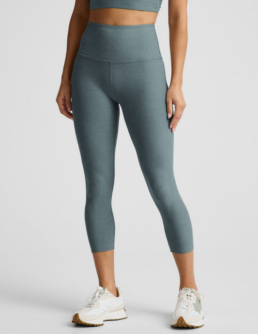 Woman wearing Green Spacedye™ Walk And Talk High Waisted Capri Legging paired with white sneakers and a matching top.