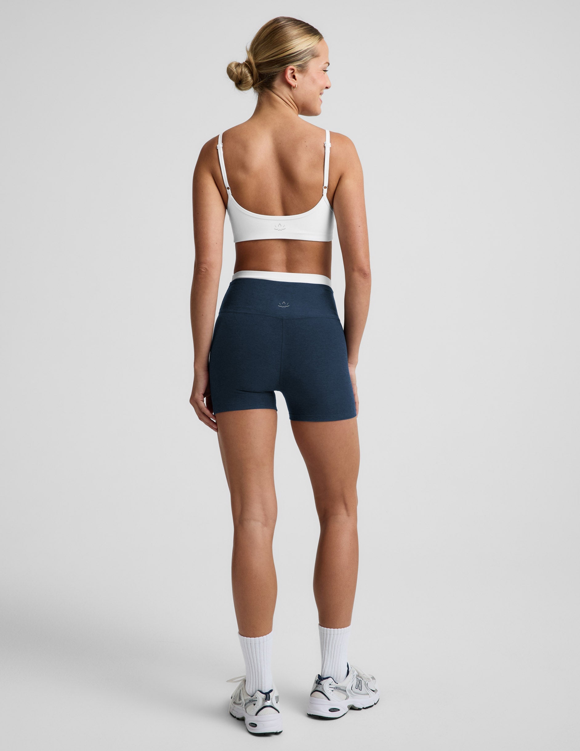 Woman wearing Navy Spacedye™ Layered 3" Short with a double layer waistband, paired with a white sports bra, rear view.