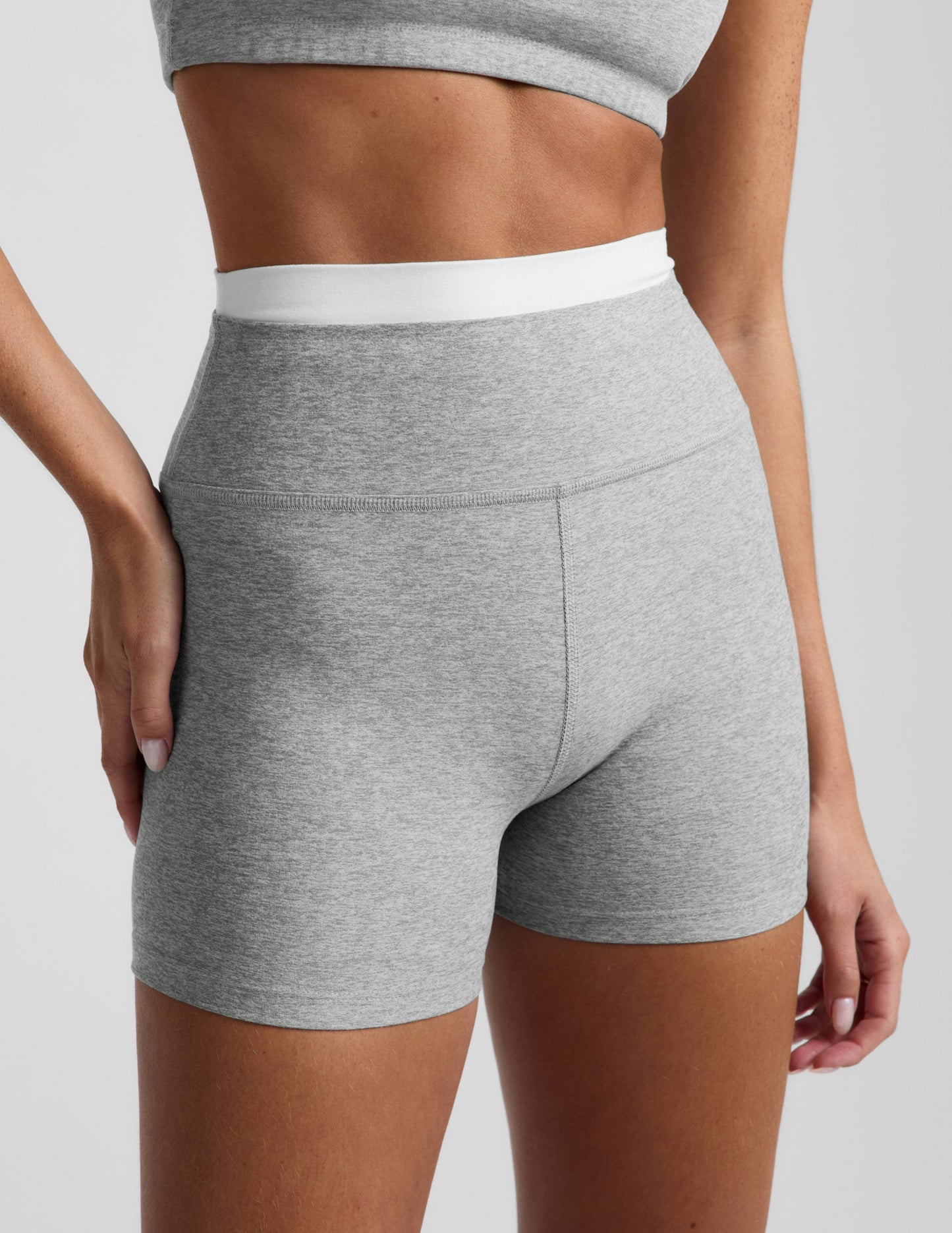 Woman wearing Gray Spacedye™ Layered 3" Short with a double contrast waistband, paired with a matching gray sports bra.