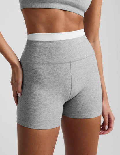 Woman wearing Gray Spacedye™ Layered 3" Short with a double contrast waistband, paired with a matching gray sports bra.