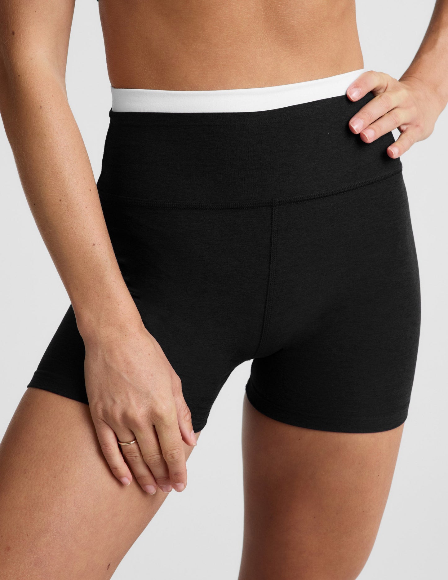 Woman wearing Black Spacedye™ Layered 3" Short with a white contrast waistband, paired with a black sports bra.