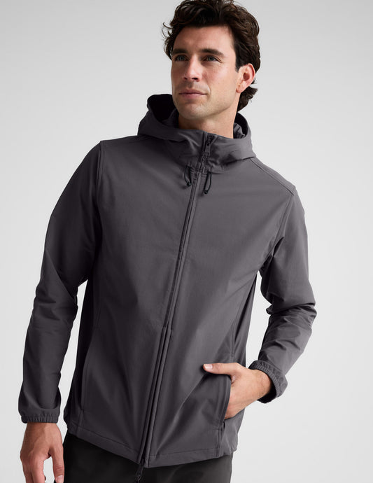 Man wearing a gray hooded jacket on a light gray background.