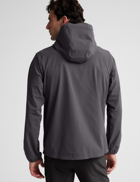 Man wearing a gray hooded jacket on a light gray background.